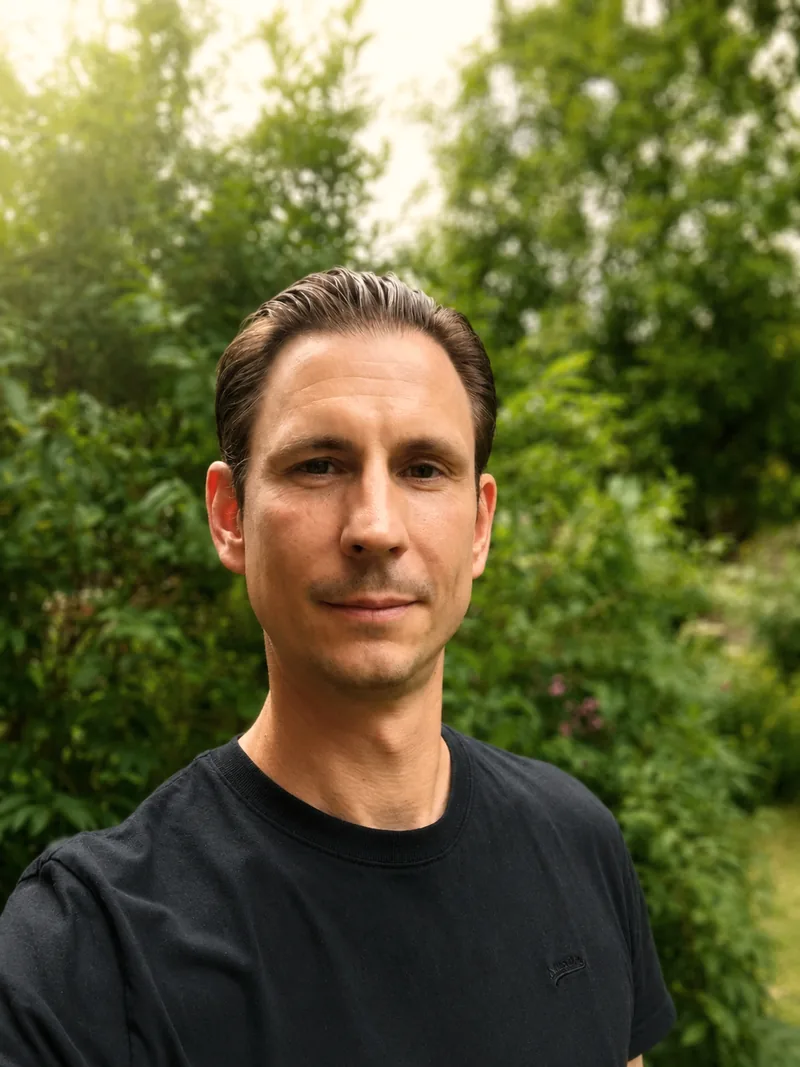 Aidan Sharp, person-centred counsellor, standing in a green garden